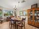 Traditional dining room with natural light, wood floors, and classic furniture at 8404 Winding Wood Dr, Port Richey, FL 34668