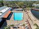 Aerial view of sparkling pool, lounge chairs and dining area at 8404 Winding Wood Dr, Port Richey, FL 34668