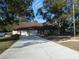 Charming one-story home featuring a spacious driveway and a two-car garage at 8526 Delaware Dr, Weeki Wachee, FL 34607