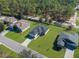 This aerial showcases a serene neighborhood with lush lawns and well-spaced homes surrounded by greenery at 8828 Mississippi Run, Weeki Wachee, FL 34613