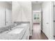 Bathroom with a granite countertop, double sinks, and modern fixtures at 8828 Mississippi Run, Weeki Wachee, FL 34613