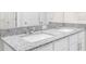 Bright bathroom featuring a double sink vanity with granite countertops and modern fixtures at 8828 Mississippi Run, Weeki Wachee, FL 34613