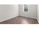 A bedroom with a large window and attractive flooring at 8828 Mississippi Run, Weeki Wachee, FL 34613