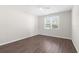 Bedroom featuring wood-look floors, a ceiling fan and a window at 8828 Mississippi Run, Weeki Wachee, FL 34613
