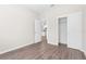 Bedroom displaying wood-look floors, closet and doorway at 8828 Mississippi Run, Weeki Wachee, FL 34613