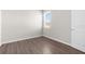 Bedroom with hardwood floors, a window, and a door at 8828 Mississippi Run, Weeki Wachee, FL 34613