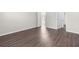 A spacious room boasts stylish wood-look flooring and neutral walls at 8828 Mississippi Run, Weeki Wachee, FL 34613