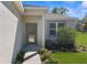Inviting front entrance with landscaped walkway and modern door at 8828 Mississippi Run, Weeki Wachee, FL 34613