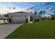 Charming single Gathering home featuring a two car garage, new landscaping and a well manicured lawn at 8828 Mississippi Run, Weeki Wachee, FL 34613