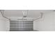 Two car garage featuring an automatic door and ample ceiling storage at 8828 Mississippi Run, Weeki Wachee, FL 34613