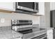 Stainless steel stove and microwave in a modern kitchen at 8828 Mississippi Run, Weeki Wachee, FL 34613