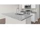 Kitchen island featuring gray granite countertop and stainless steel faucet at 8828 Mississippi Run, Weeki Wachee, FL 34613