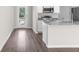 Bright kitchen featuring granite countertops and stainless steel appliances at 8828 Mississippi Run, Weeki Wachee, FL 34613