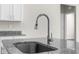 Modern kitchen sink with granite countertops and chrome faucet at 8828 Mississippi Run, Weeki Wachee, FL 34613