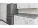 Modern kitchen features stainless steel appliances and granite countertops at 8828 Mississippi Run, Weeki Wachee, FL 34613