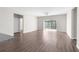 Spacious living room with hardwood floors and sliding glass doors at 8828 Mississippi Run, Weeki Wachee, FL 34613