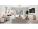 Living room boasts contemporary design with neutral tones, stylish seating, and sliding glass doors at 8828 Mississippi Run, Weeki Wachee, FL 34613