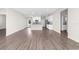 Spacious open-plan living room showcasing hardwood floors and natural light at 8828 Mississippi Run, Weeki Wachee, FL 34613