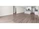 Bright living room boasts hardwood floors with open layout to the kitchen at 8828 Mississippi Run, Weeki Wachee, FL 34613