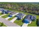Overhead shot of multiple single Gathering homes each with driveway and lush green lawns at 9062 Wade St, Brooksville, FL 34613