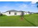 A large backyard with lush green grass and patio doors leading into the home at 9062 Wade St, Brooksville, FL 34613