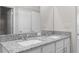 Bathroom featuring double sinks with granite countertops and white cabinets at 9062 Wade St, Brooksville, FL 34613