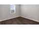 Clean bedroom offers a window with blinds and hard floors at 9062 Wade St, Brooksville, FL 34613