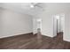 Bright bedroom featuring a ceiling fan and wood-look flooring at 9062 Wade St, Brooksville, FL 34613