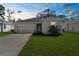 Charming single-story home with a well-maintained lawn and a two-car garage on a sunny day at 9062 Wade St, Brooksville, FL 34613