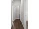 Hallway with wood-look flooring leading to laundry room with a white washer and dryer at 9062 Wade St, Brooksville, FL 34613