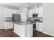 Modern kitchen featuring white cabinets, stainless steel appliances, granite countertops, and a center island at 9062 Wade St, Brooksville, FL 34613