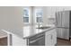 Bright kitchen boasts granite counters, stainless steel appliances, and a central island with a sink at 9062 Wade St, Brooksville, FL 34613