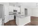 Kitchen features white cabinetry, granite countertops, an island and stainless steel appliances at 9062 Wade St, Brooksville, FL 34613