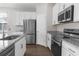 Modern kitchen featuring stainless steel appliances and granite countertops with a kitchen sink at 9062 Wade St, Brooksville, FL 34613