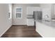 Kitchen featuring stainless steel appliances, white cabinets, granite countertops, and wood-look floors at 9062 Wade St, Brooksville, FL 34613