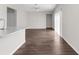 Bright living room adjacent to the kitchen with wood-look flooring and sliding glass doors at 9062 Wade St, Brooksville, FL 34613