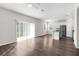 Open floor plan with hard floors and sliding glass doors, leading to the kitchen and dining area at 9062 Wade St, Brooksville, FL 34613