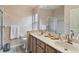 Bathroom with a double sink vanity, window for natural light, and walk-in shower at 9336 Creekside Ct, Hudson, FL 34669