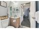 Well-lit bathroom with a sink, toilet, and storage, seamlessly connected to the hallway at 9336 Creekside Ct, Hudson, FL 34669