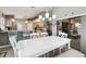 Open-concept dining room with a large table, seamless flow into the kitchen, and neutral tones at 9336 Creekside Ct, Hudson, FL 34669