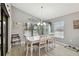 Bright dining room with a white table and chairs beneath an elegant chandelier at 9336 Creekside Ct, Hudson, FL 34669