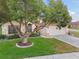 Well-maintained home featuring an oversized tree in a landscaped front yard and two-car garage at 9336 Creekside Ct, Hudson, FL 34669