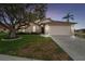 Charming single-Gathering home featuring a well-manicured lawn, mature trees, and a two-car garage at 9336 Creekside Ct, Hudson, FL 34669