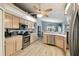 Modern kitchen featuring stainless steel appliances and light wood cabinets at 9336 Creekside Ct, Hudson, FL 34669