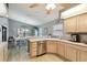 Bright kitchen features stainless steel appliances, ample countertop space, and light wood cabinets at 9336 Creekside Ct, Hudson, FL 34669