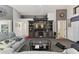 Spacious living room with a large entertainment center, neutral tones, and comfortable seating at 9336 Creekside Ct, Hudson, FL 34669