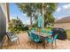 Outdoor patio with dining set, grill, and lush landscaping, perfect for entertaining at 9336 Creekside Ct, Hudson, FL 34669