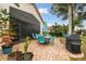 Outdoor patio with a dining set, grill, and lush landscaping, perfect for entertaining at 9336 Creekside Ct, Hudson, FL 34669