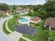 Aerial view of the community pool surrounded by lush greenery and residential properties at 9336 Creekside Ct, Hudson, FL 34669