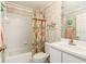 Bathroom featuring a tub with shower, decorative wallpaper, and a single sink at 9405 Palm Haven Ct, New Port Richey, FL 34655